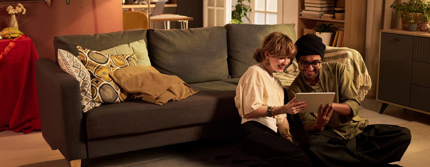 Happy Couple Looking at their Tablet