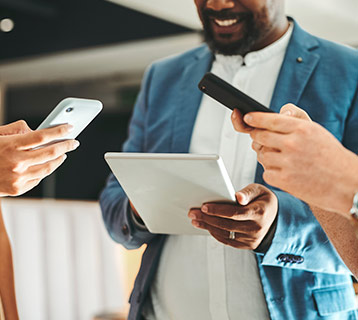 a group of adults looking at their mobile devices