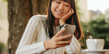 woman smiling looking at phone